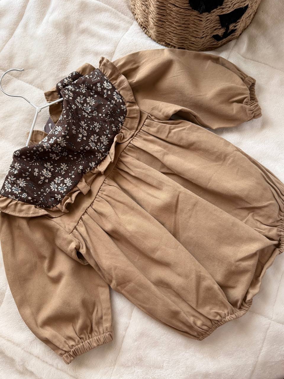 Brown baby romper with a floral print and collar