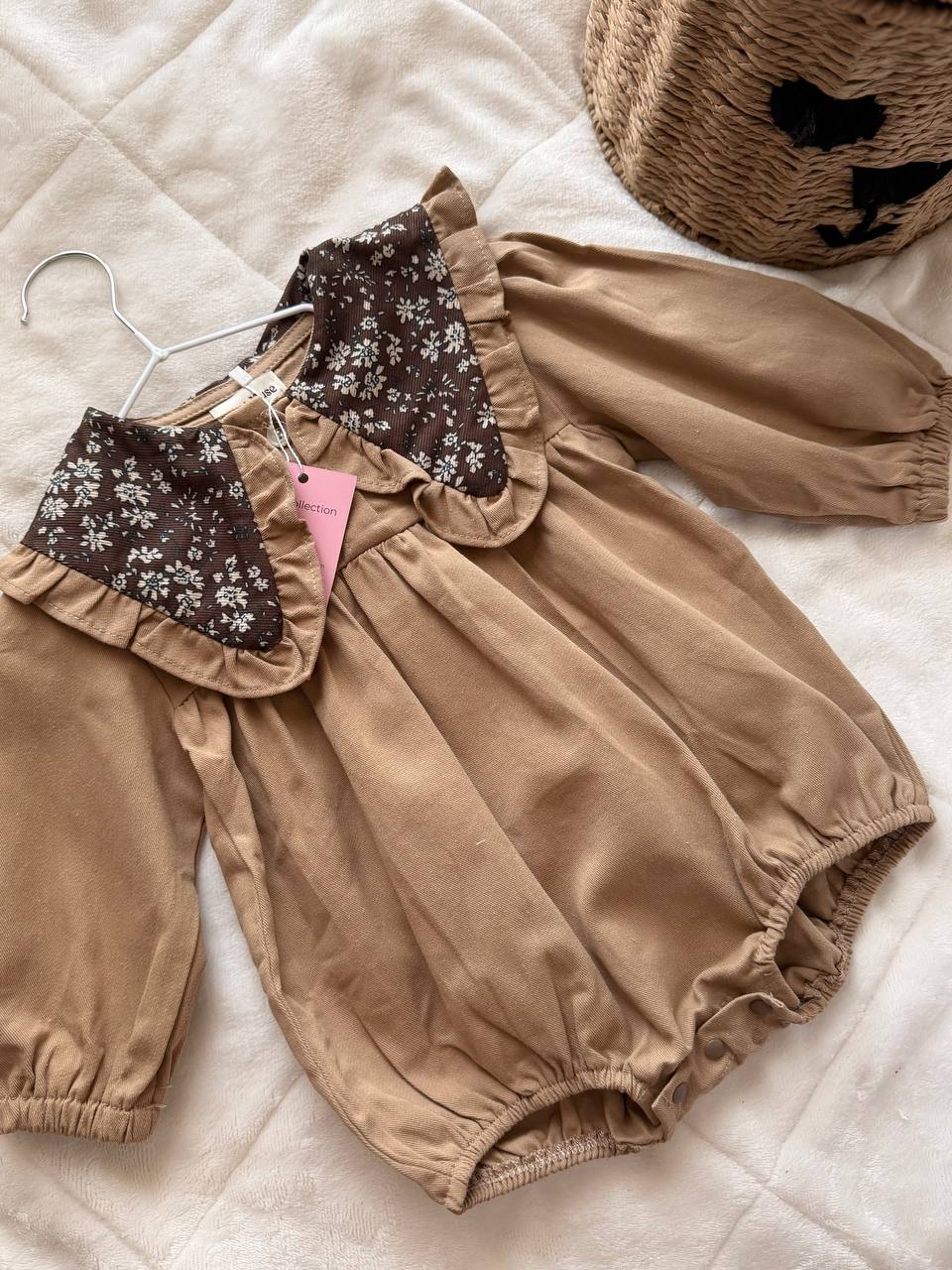 Brown baby romper with a floral print and collar